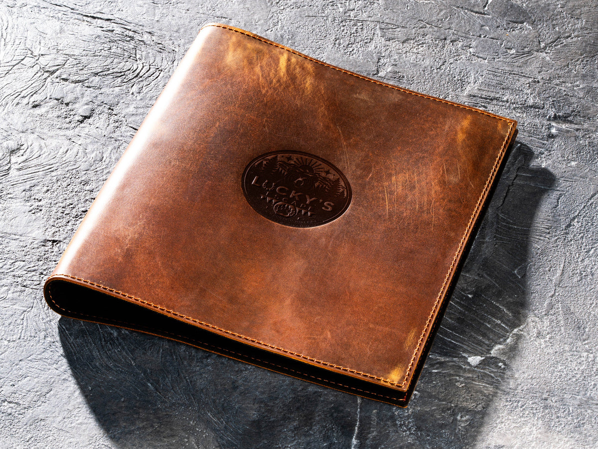Personalized Chestnut leather corporate binder with large custom logo embossed on the front cover