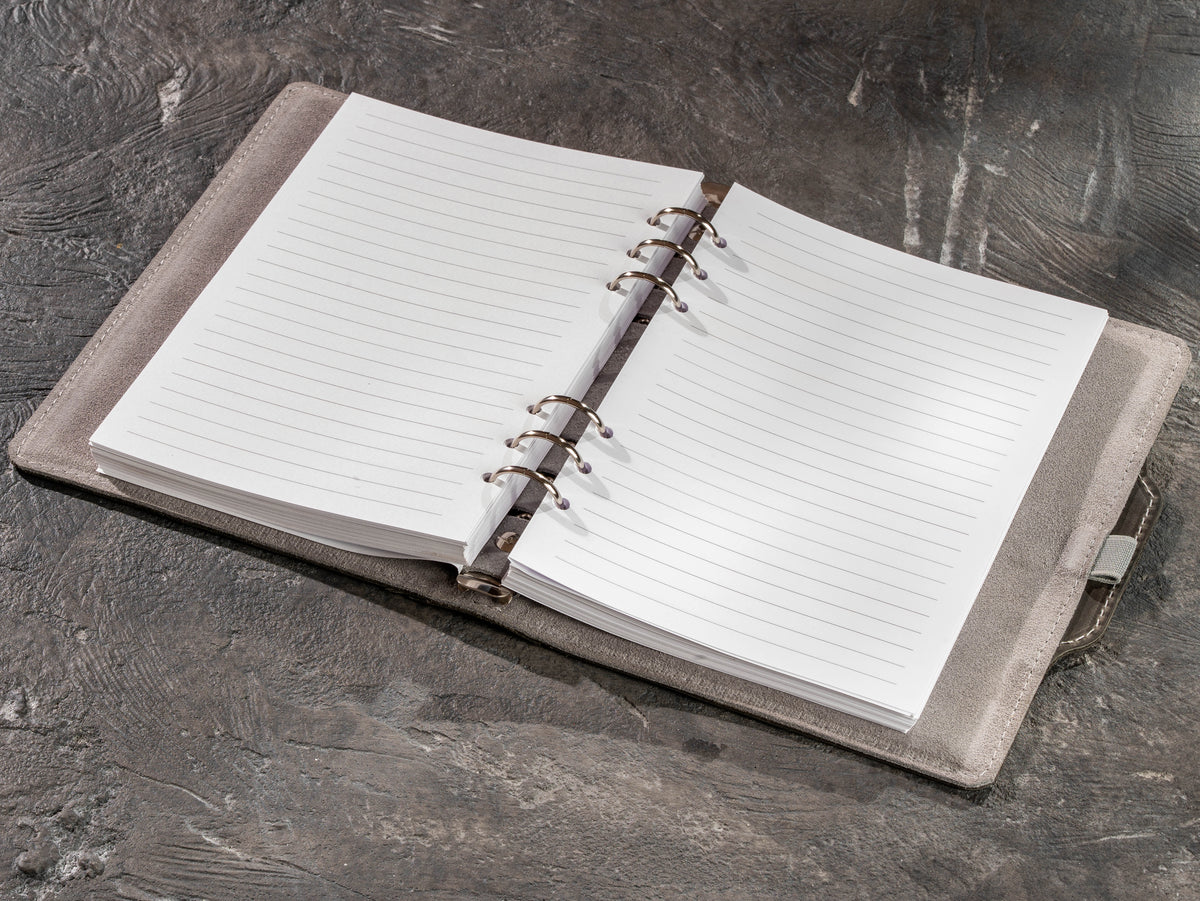 Open gray leather refillable notebook with lined A5 and 8.5 x 5.5 pages