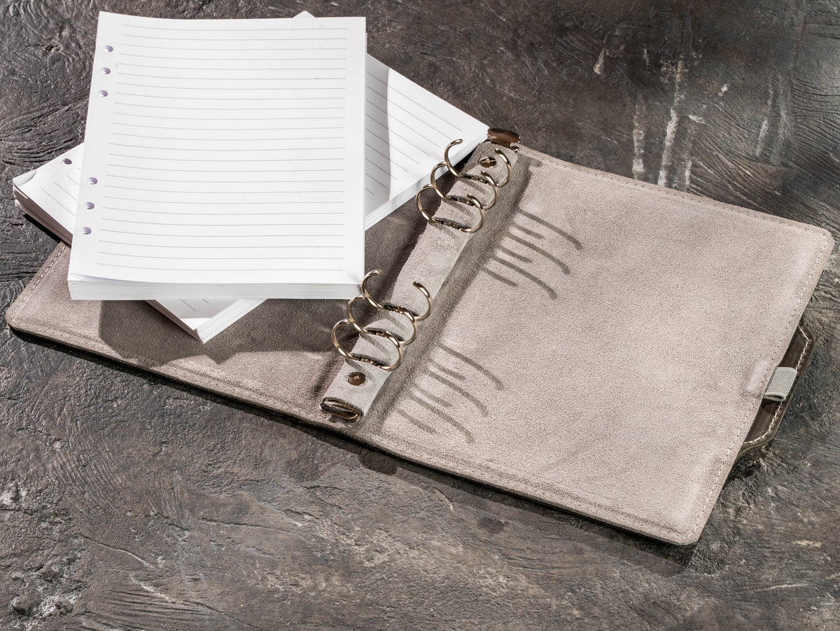 Gray leather notebook with removable lined pages and refillable ring mechanism
