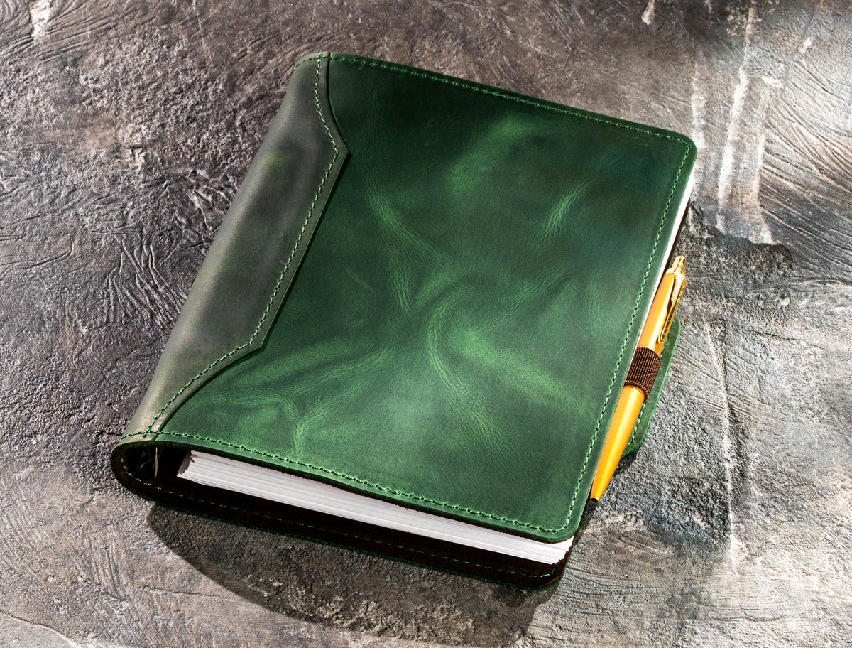 Green leather A5 and 8.5 x 5.5 notebook with gold pen secured in elastic pen loop