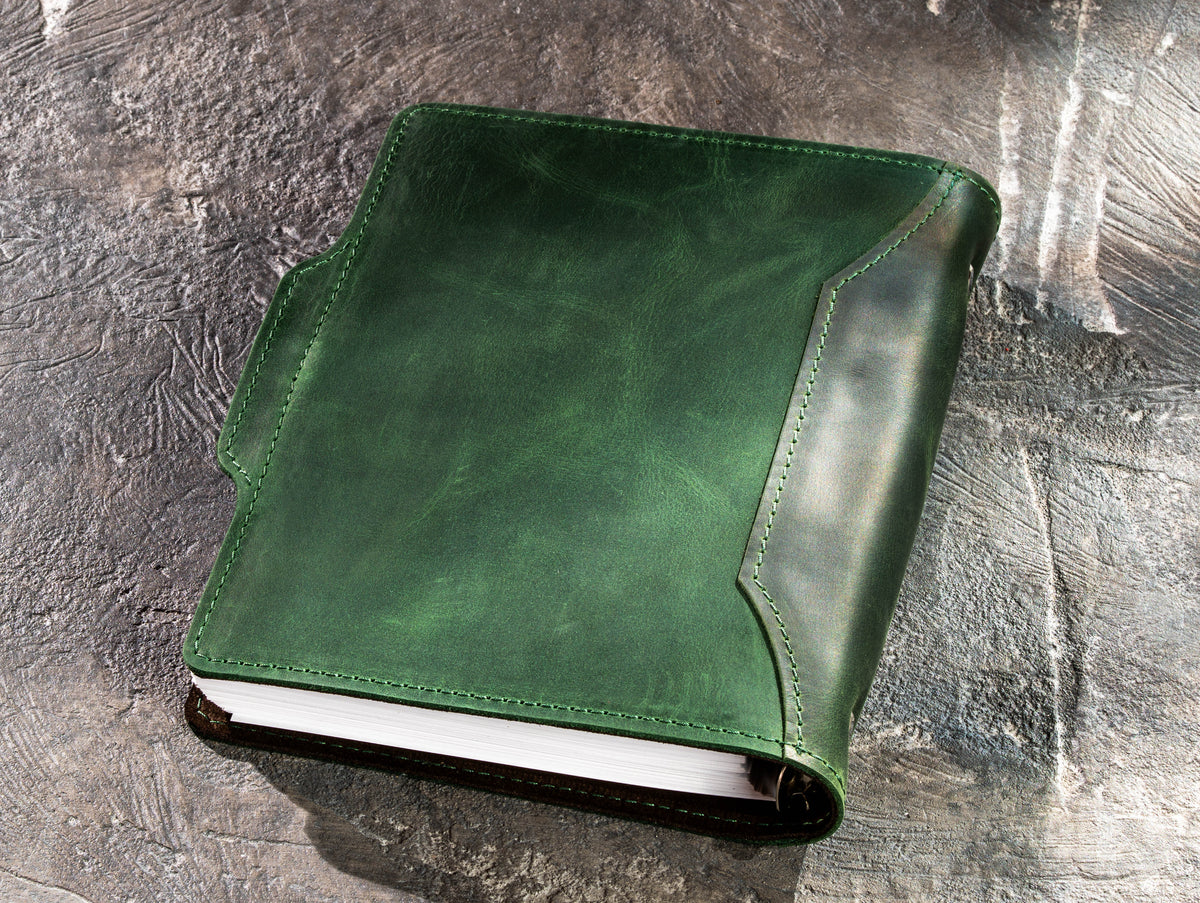 Back view of green leather refillable business notebook showing stitched cover