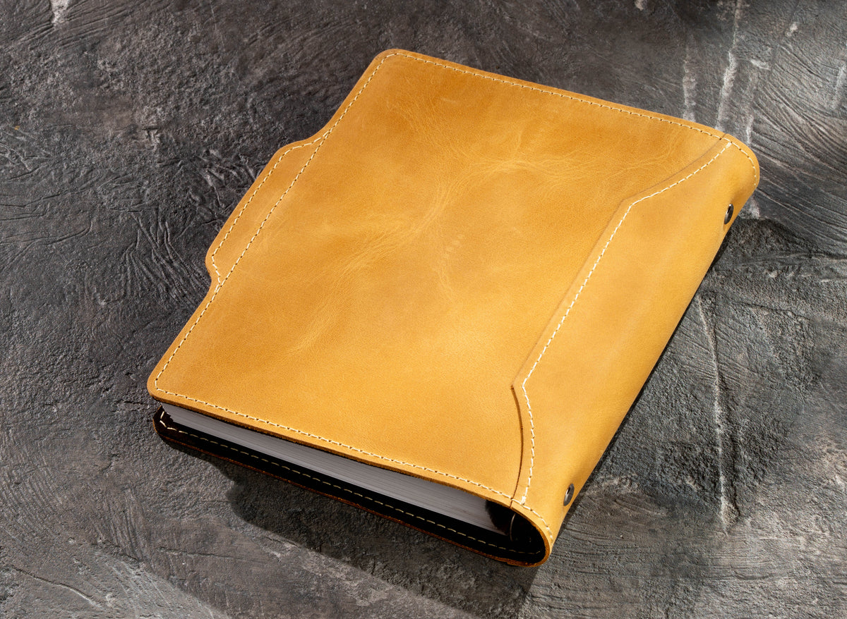 Back view of yellow leather business notebook showing natural leather texture and stitched cover