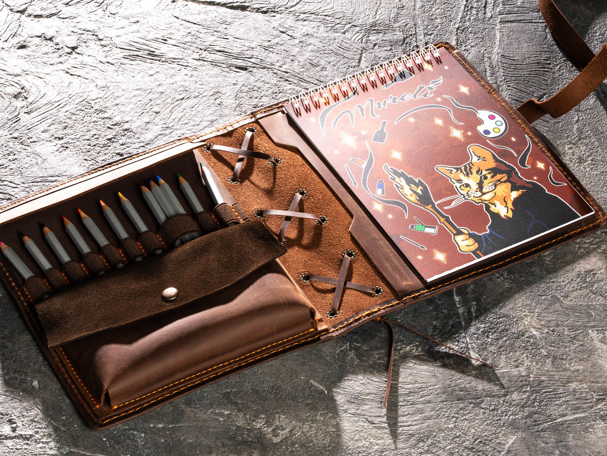 Open zipper-free brown leather artist organizer with A5 sketchbook, pencils and expanded tool pockets