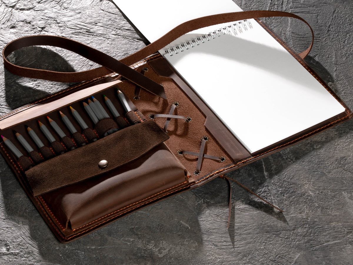 Brown leather sketchbook organizer with A5 spiral sketchbook, pencil holders and wider open accessory pockets
