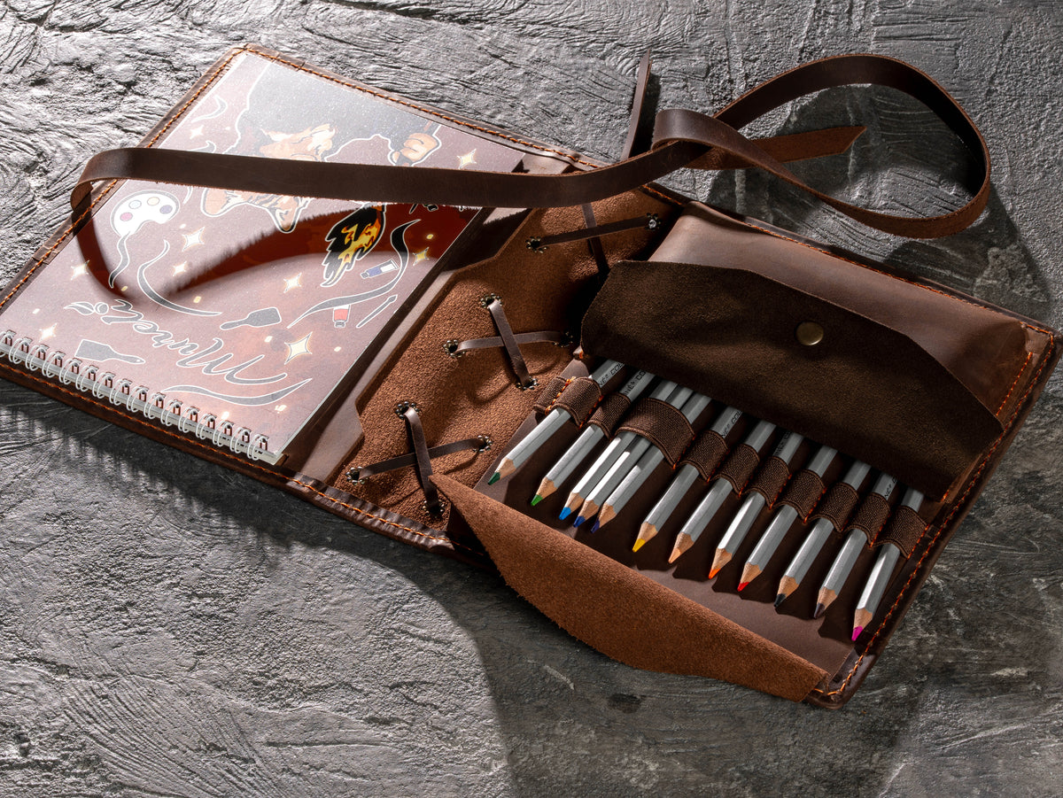 Zipper-free brown leather artist organizer with widened pencil slots and open tool pocket for sketching supplies