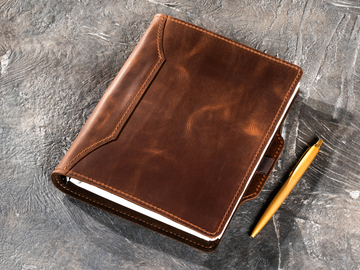 Milk Chocolate leather notebook with gold pen beside the cover