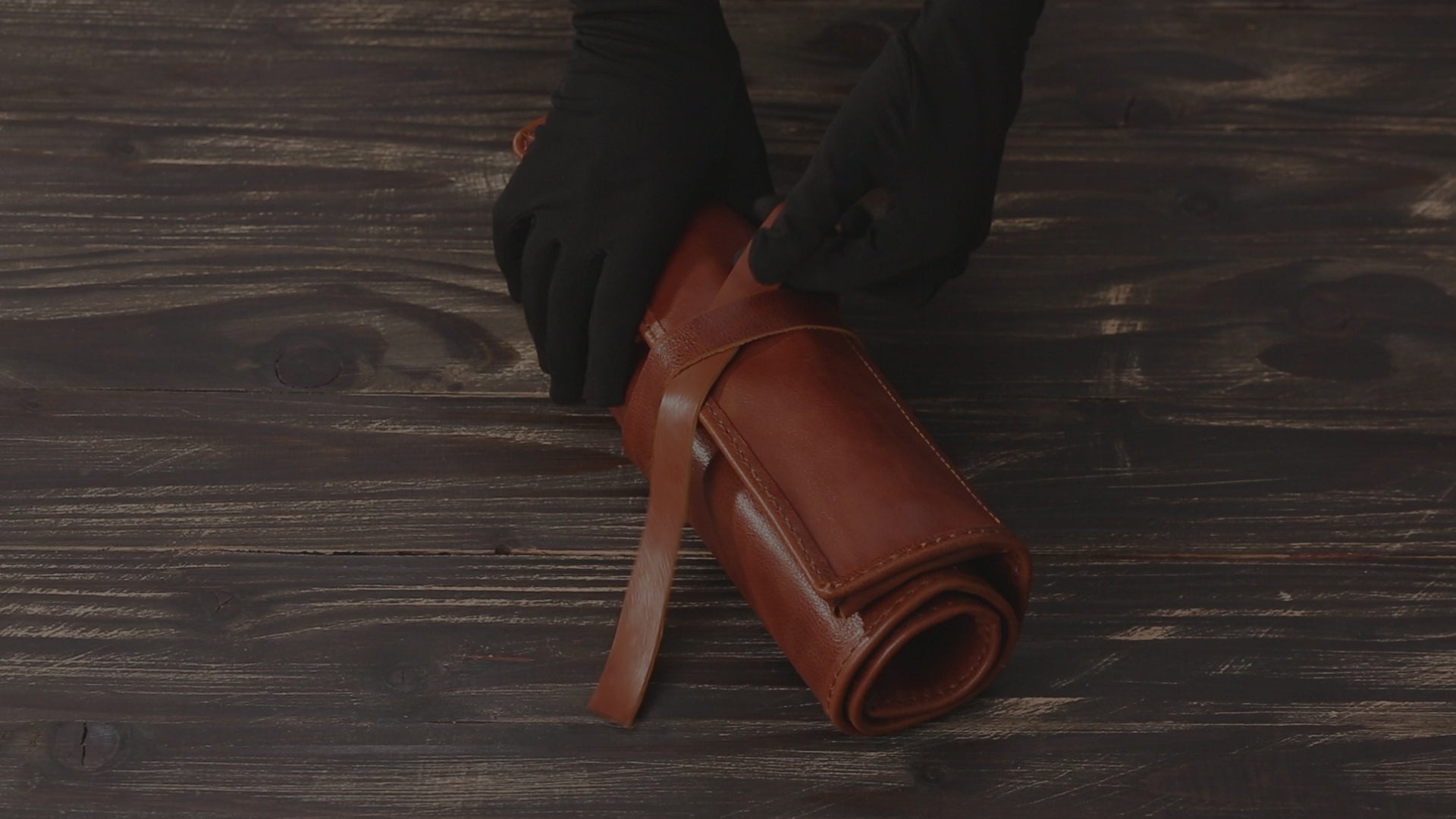 Video showcasing the handcrafted leather artist roll in Cognac Brown, featuring personalized name embossing and organized compartments for brushes, pencils, and tools.